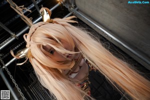 A woman tied up with blood on her body.