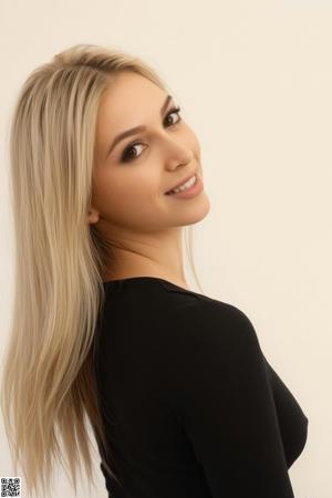 A woman in a black dress posing for the camera.