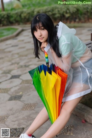 A woman in a white dress holding an umbrella.