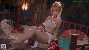 A woman in a red and white lingerie posing for a picture.