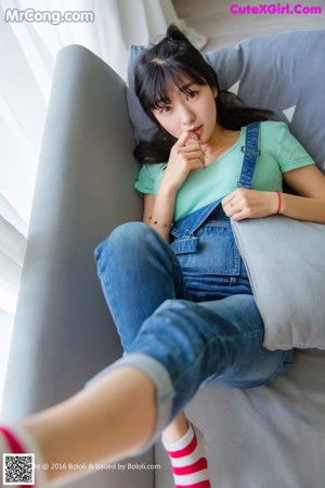 A woman laying on top of a bed with a pillow.