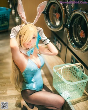 A woman in a bunny costume sitting in front of a mirror.