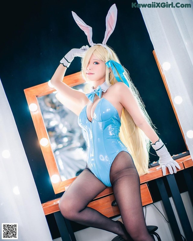 A woman in a bunny costume posing in front of a mirror.