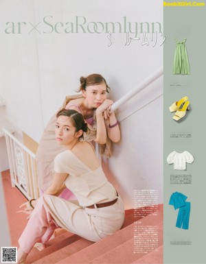 A couple of women standing next to each other in front of lockers.