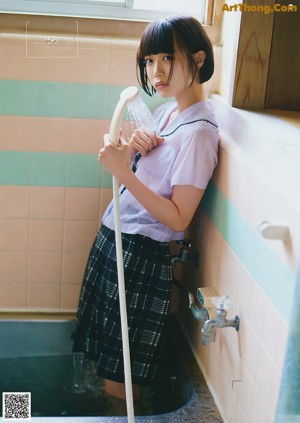 A woman in a white shirt is posing for a magazine.