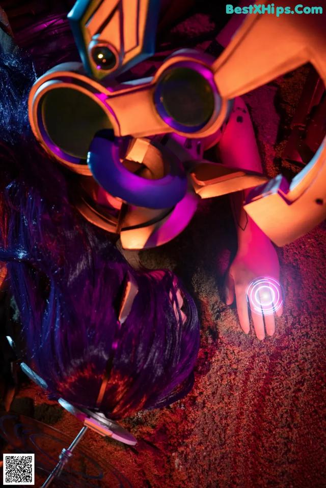 A woman with purple hair and a robot head.