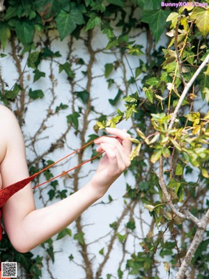 A woman in a red dress posing for a picture.