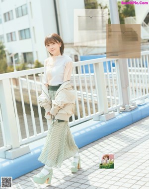 A woman in a white shirt is posing for a magazine.