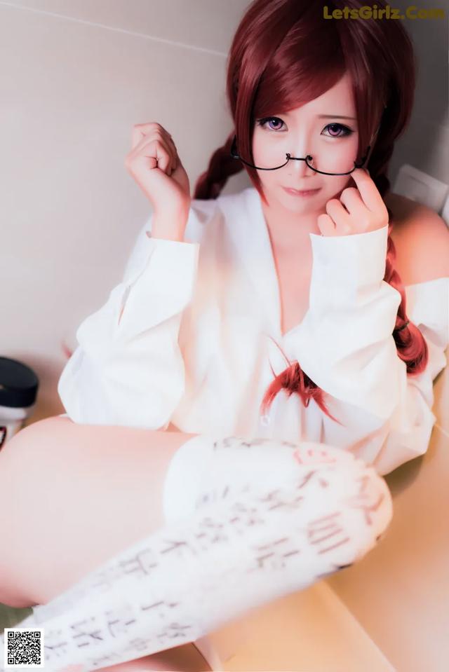 A woman in a white shirt and glasses sitting on a bathtub.