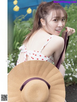 A woman in a black bra and panties posing for a magazine.