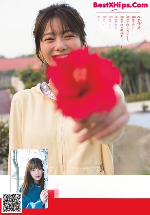 A woman holding chopsticks in front of her face.