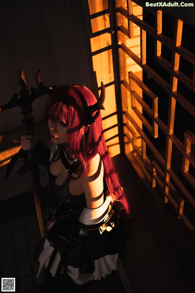 A woman with red hair holding a sword in her hand.