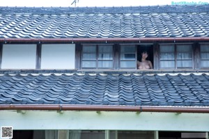 A naked asian woman posing for the camera. 