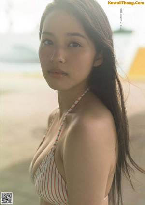 A young woman in a school uniform posing for a magazine.