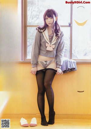 A woman in a maid outfit is posing for a magazine.