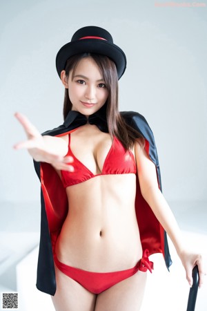 A woman in a red bikini and a black hat.