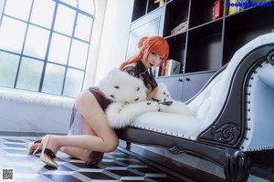 A woman sitting on a window sill with a teddy bear.