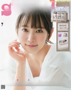 a woman in a red top and plaid skirt posing for a magazine