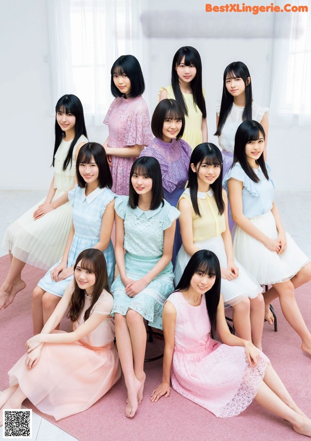 A group of young women sitting on a pink rug.