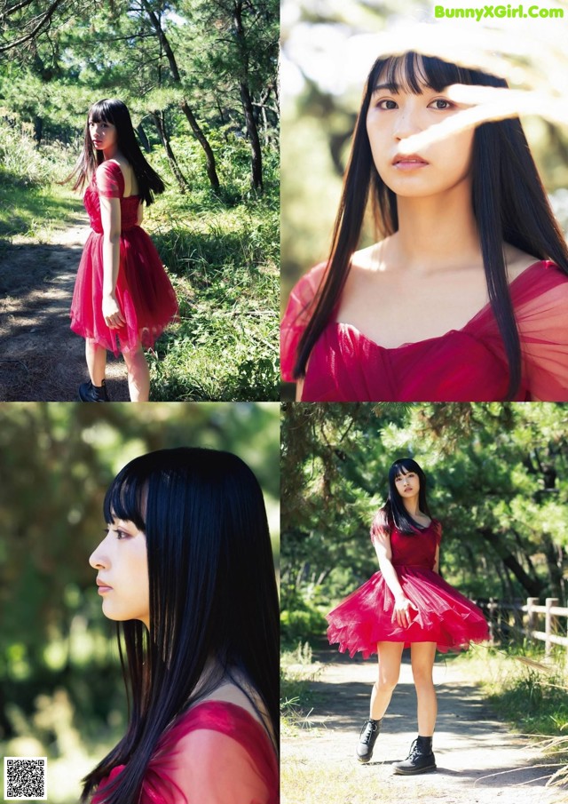 A woman in a red dress is posing for a picture.