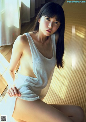 A woman in a white sweater is posing for a magazine cover.