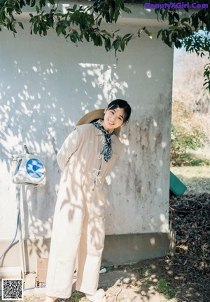 A woman in a blue kimono posing for a picture.