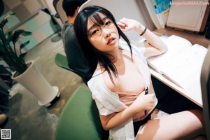A woman sitting in front of a laptop computer.